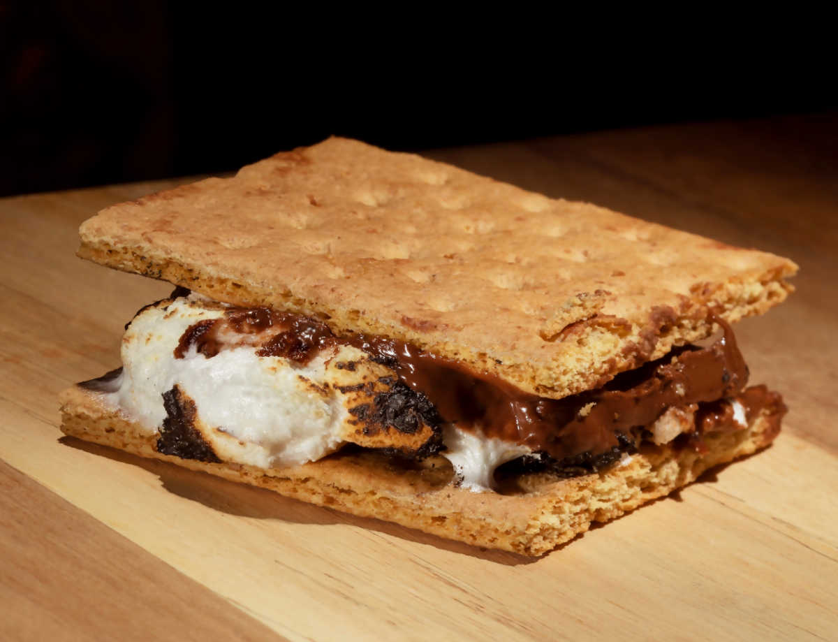 Warm s'mores with marshmallow and melted chocolate.