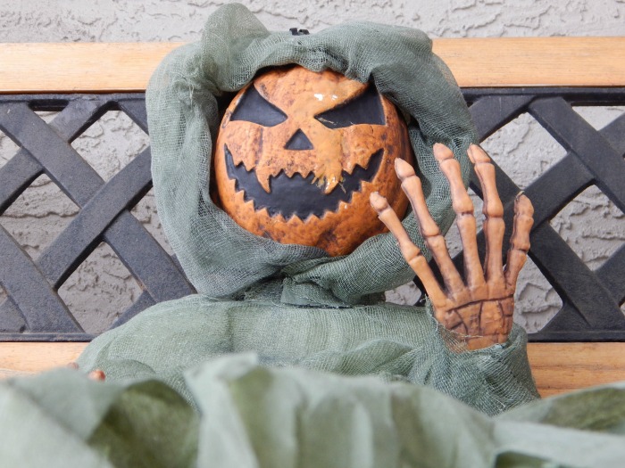 pumpkin head and skeleton hand wrapped in burlap Life sized pumpkin ghoul