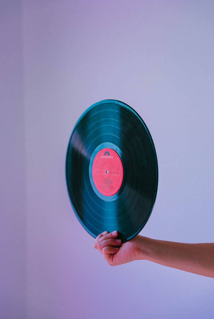 a person holding a vinyl record in the air vinyl or shellac record