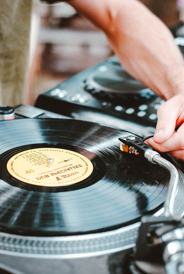 a man spinning vinyl on a turntable vinyl record on a turntable