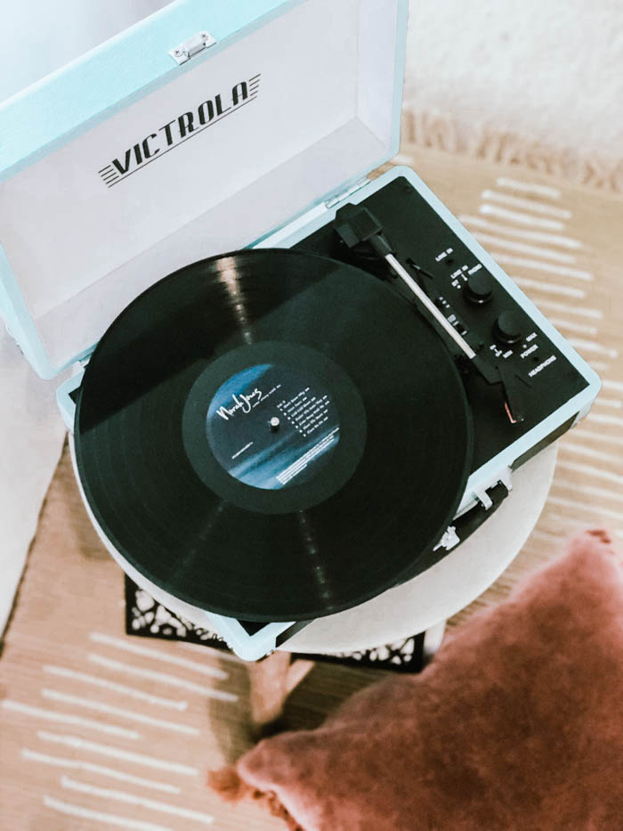 a victrola suitcase record player sitting on a stool victrola suitcase record player