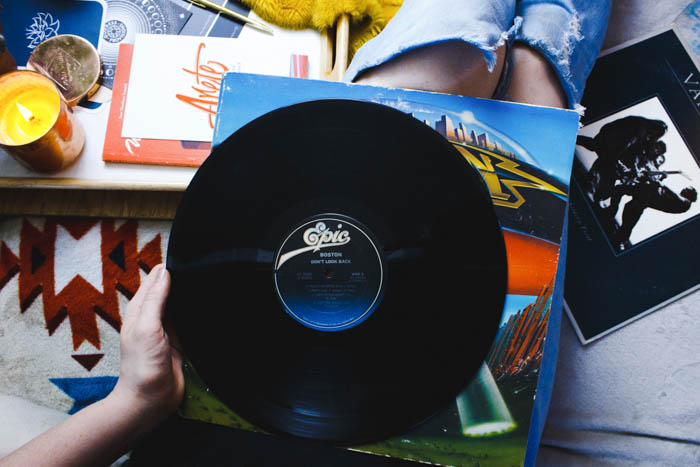 a person sitting holding a vinyl record vinyl record