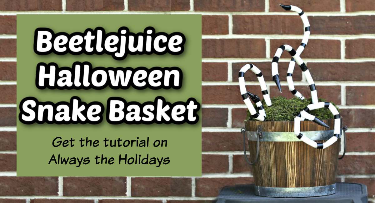 A scary snake basket against a brick wall with a white text overlay in a green square to the left of it that says Beetlejuice Halloween snake basket.