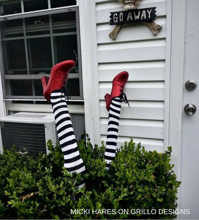 Witch legs upside down in a bush