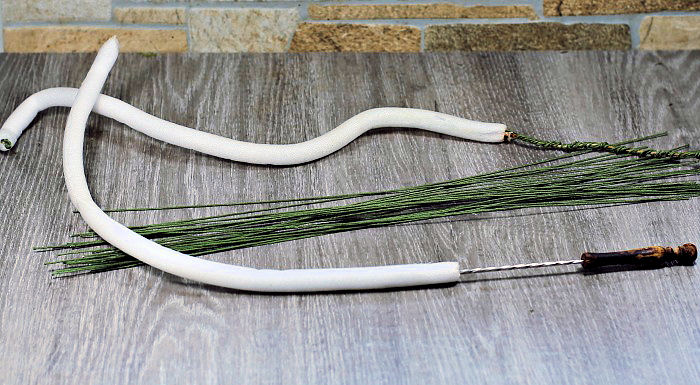 Threading the dowels Threading foam dowels with floral wire.