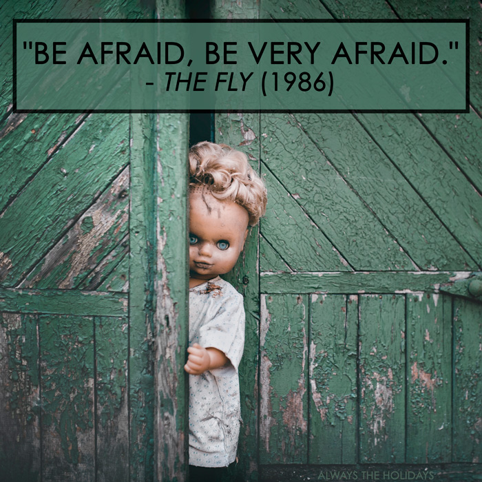 Scary doll emerging from a shed with a Halloween quote overlay. A scary doll emerging from a creepy green shed with the Halloween quote overlay "be afraid, be very afraid".