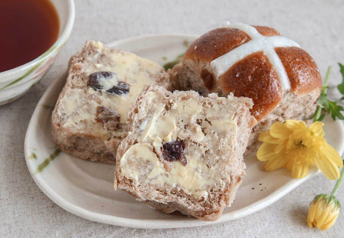 Hot cross buns day Hot cross buns on a plate with cup of coffee.