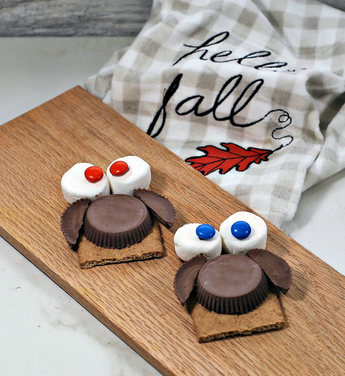 Making owl cookie treats Marshmallow eyes and peanut butter cup bodies.