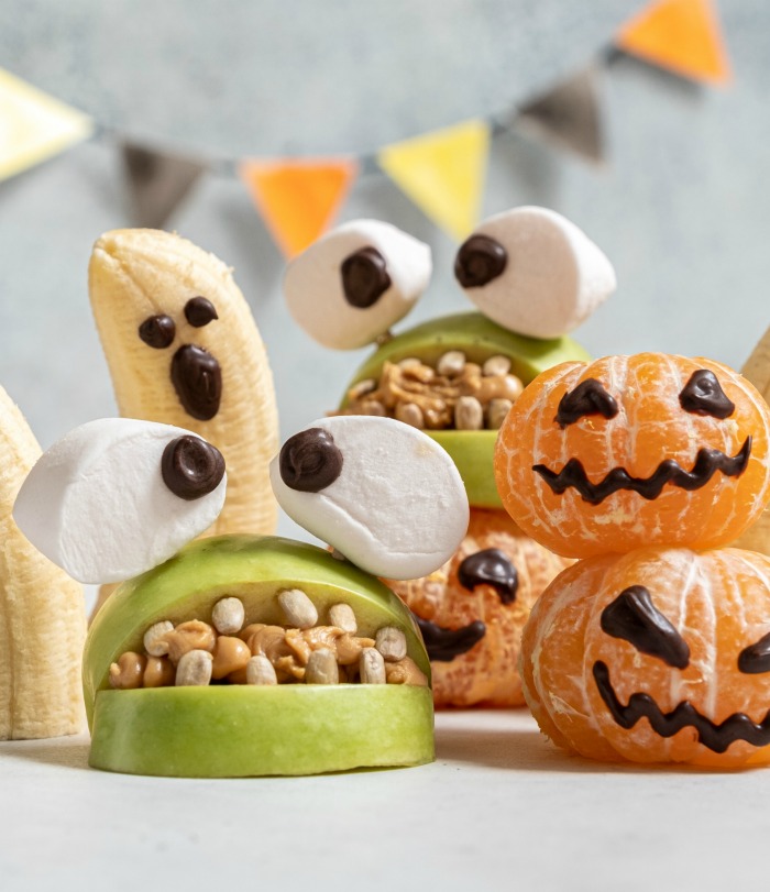monster mouth with big marshmallow eyes. Peanuts and marshmallows on apples to make mouths.