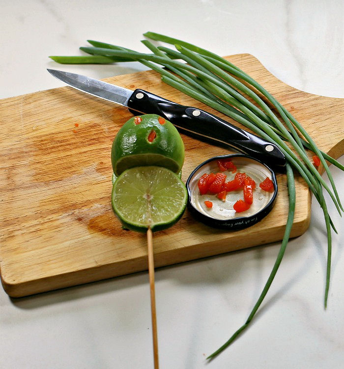 Lime with pimento pieces for a face.