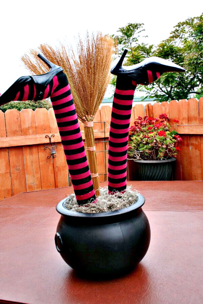 Witches legs in a black cauldron