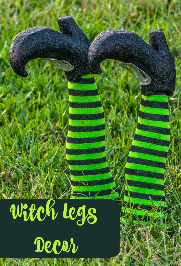Witch legs decor ideas. DIY witch legs decor overlay on two green and black striped legs with black shoes.