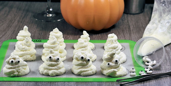 adding eyes to whipped cream ghosts. Eyes on whipped cream ghosts.