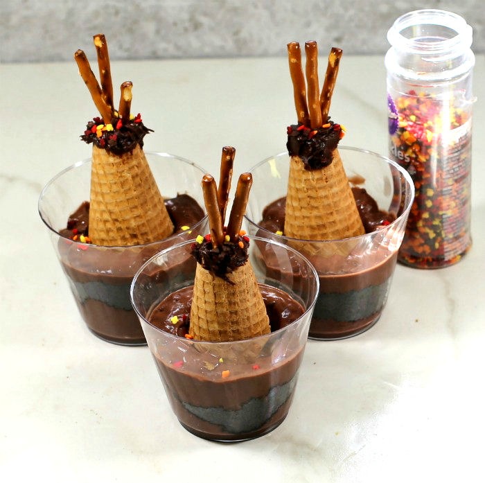 Making teepee pudding cups. Thanksgiving teepee shaped pudding ups with sprinkles.