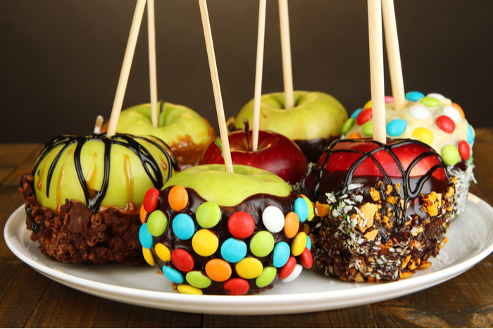 Caramel apples with candy toppings. Caramel apples with candy toppings including M&Ms, sprinkles, and chocolate drizzle.