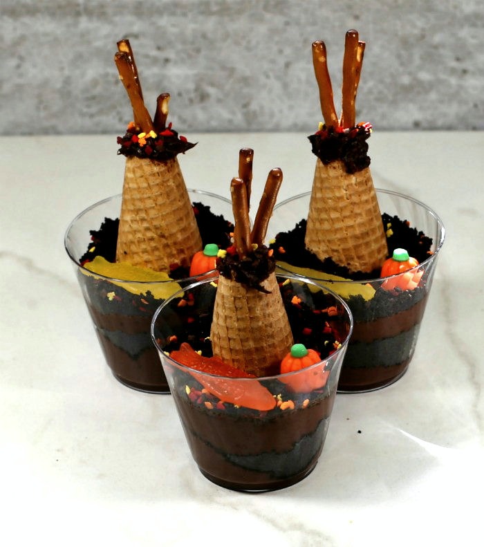 Finished dirt cups shaped like tepees. Dirt cup recipe with Swedish fish, candy pumpkin and teepees.