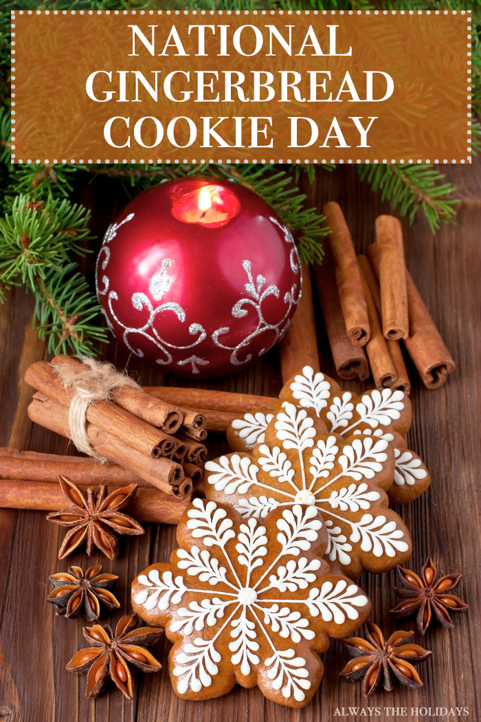 Snowflake shaped gingerbread cookies on a table next to holiday spices and pine tree branches. Snowflake shaped gingerbread cookies on a table next to Christmas spices with a text overlay that reads "National Gingerbread Cookie Day".