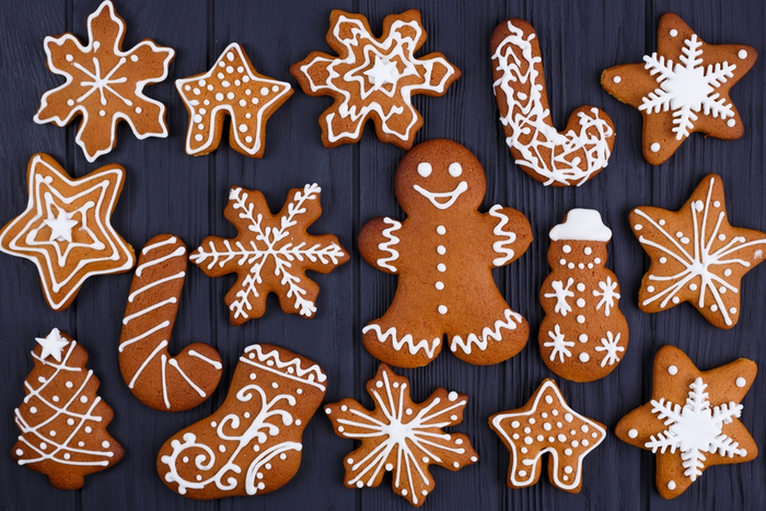 An overhead shot of a batch of iced gingerbread cookies. An overhead shot of a batch of iced gingerbread cookies.