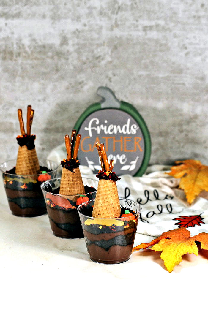 Dirt pudding cups, green pumpkin sign and, fall leaves.
