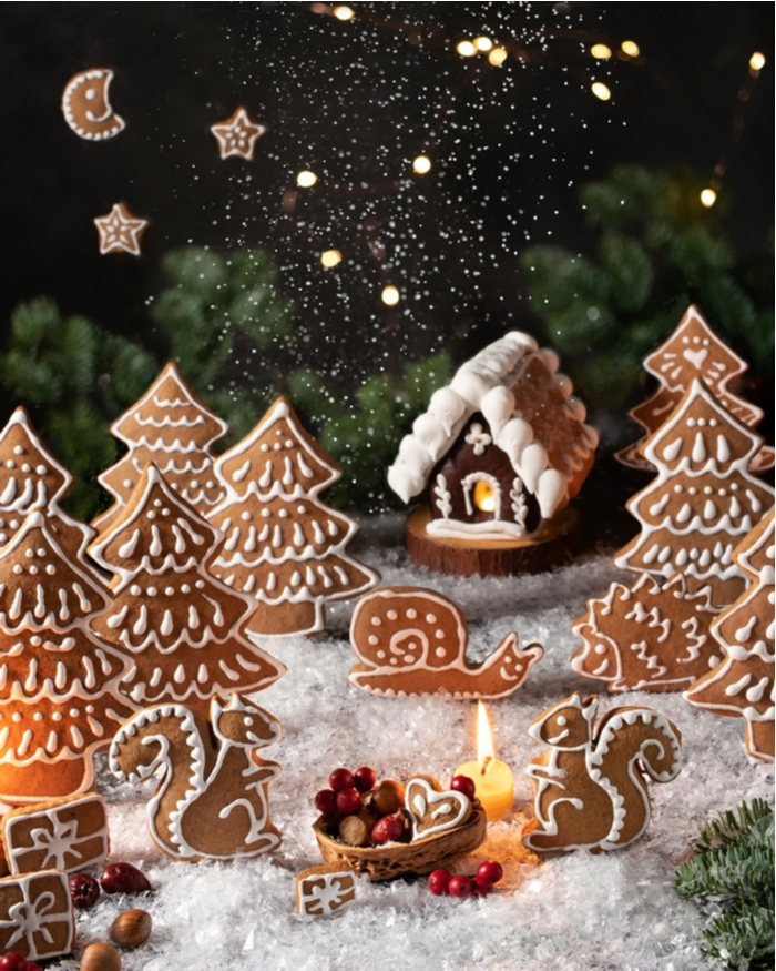 A Christmas gingerbread display with gingerbread trees, stars, a moon and a gingerbread house.