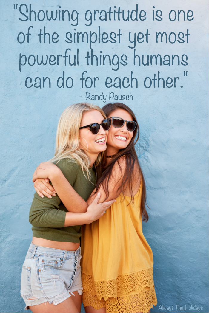 Two girls hugging in front of a blue background with a Thanksgiving grateful message text overlay reading "Showing gratitude is one of the simplest yet most powerful things humans can do for each other.".
