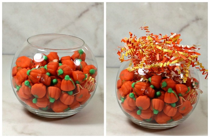 Base for the turkey pops Fish bowl filled with candy pumpkins and crinkle-cut orange and yellow shredded paper.