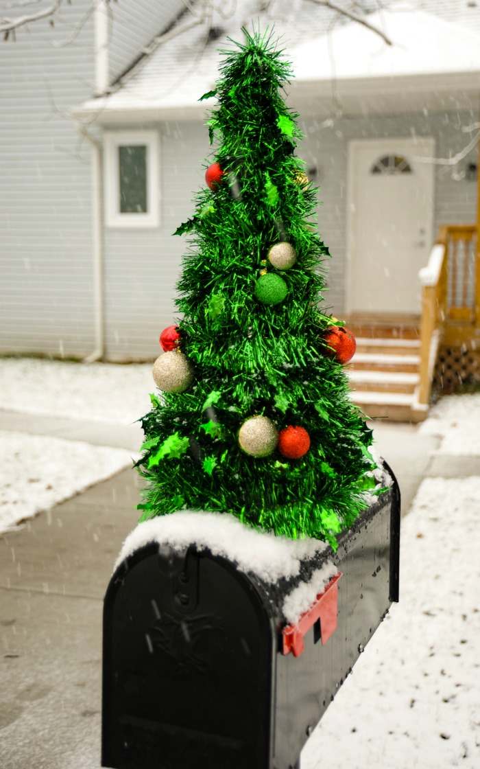Black mailbox with a Metallic Christmas Tree on Top Metallic Christmas tree on a black mailbox.
