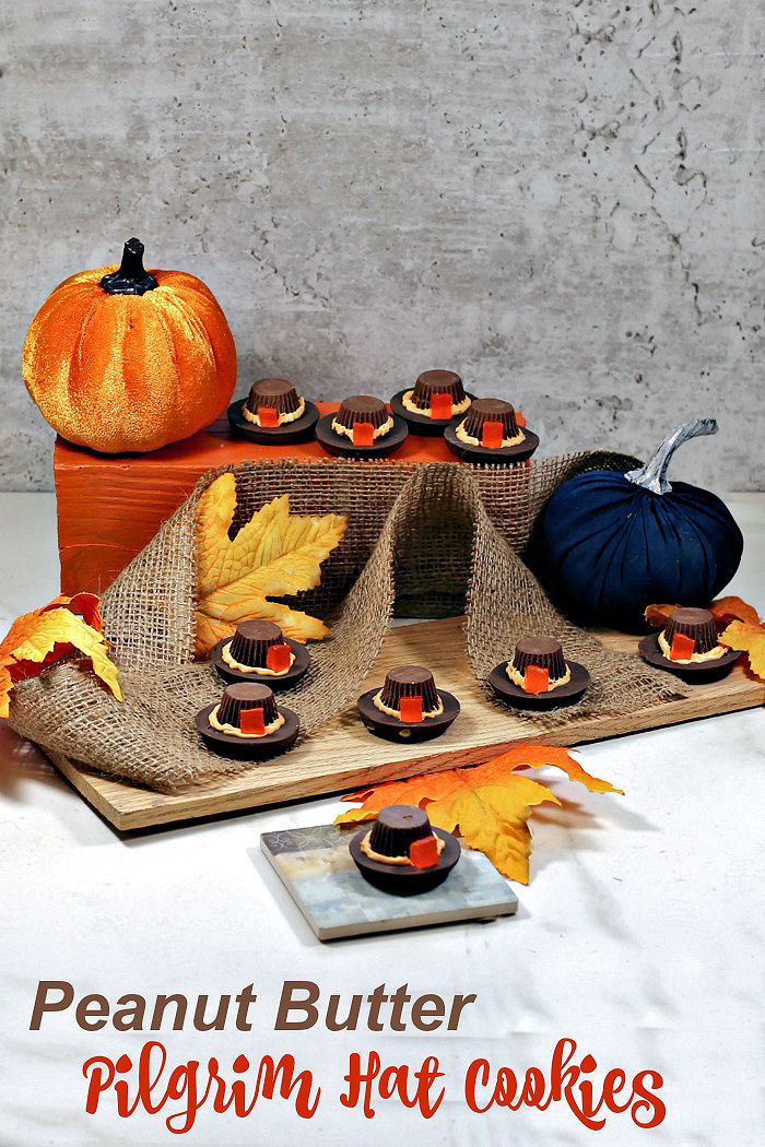 Peanut butter pilgrim hat cookies. Cookie pilgrim hats in a Thanksgiving centerpiece with burlap and silk leaves and text reading "Peanut butter pilgrim hat cookies."