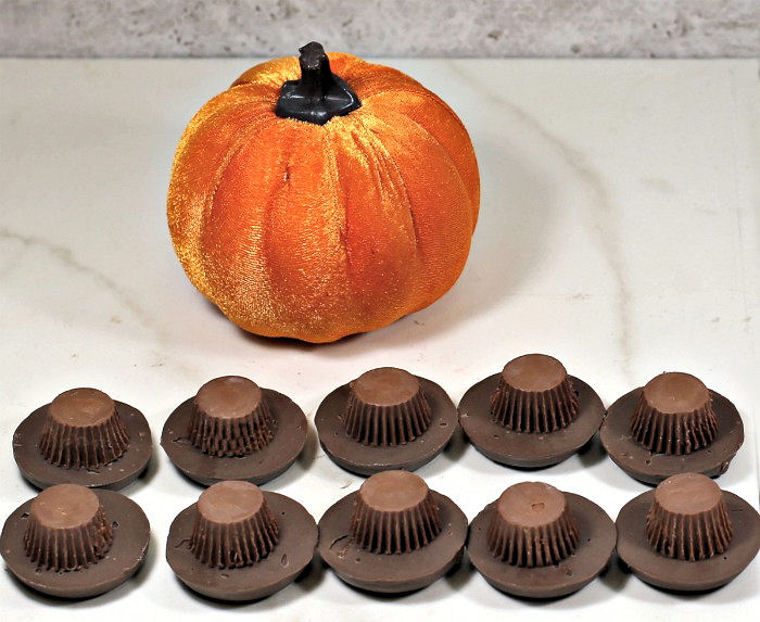 Making peanut butter hats Chocolate cookies and peanut butter cups in the shape of a hat.