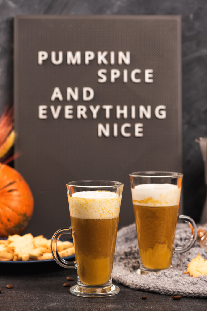 Two pumpkin spiced lattes with a text overlay reading "pumpkin spice and everything nice.".