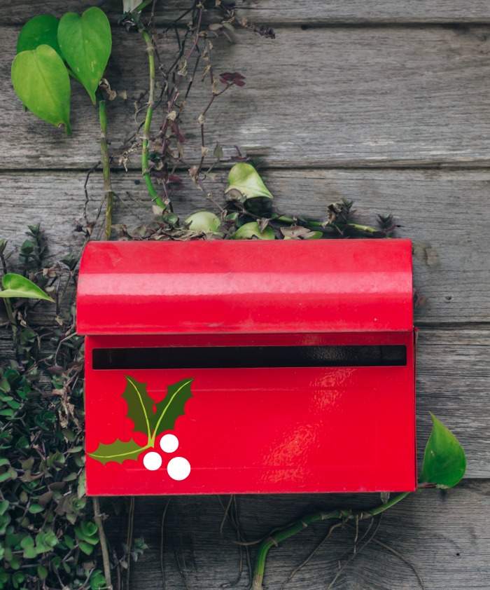 Decorated red mailbox Red mailbox decorated with holly and berry stickers.