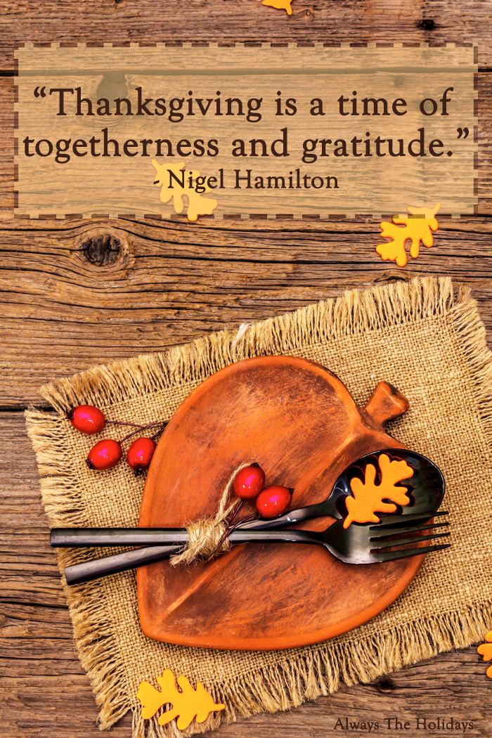 An orange plate on a burlap placemat on top of a wooden table with a Thanksgiving quote overlay.