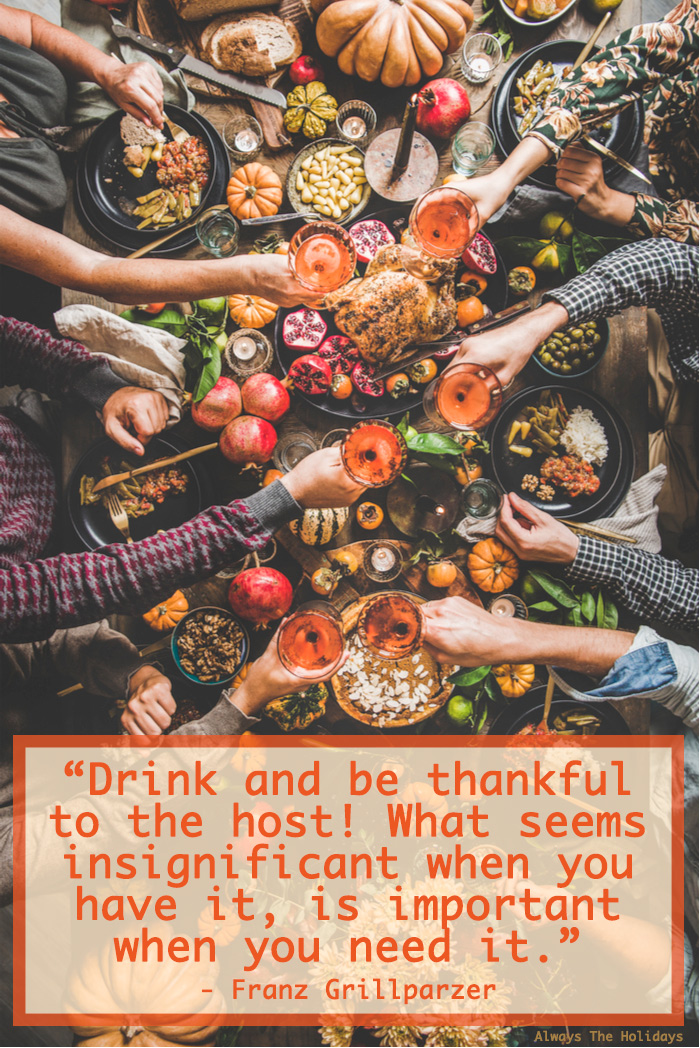 An overhead shot of a people clinking glasses over a Thanksgiving table filled with food and there is a Thanksgiving quote text overlay on the bottom.