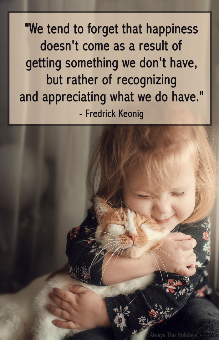 A little girl hugging a kitten with a Thanksgiving thankful quote overlay.