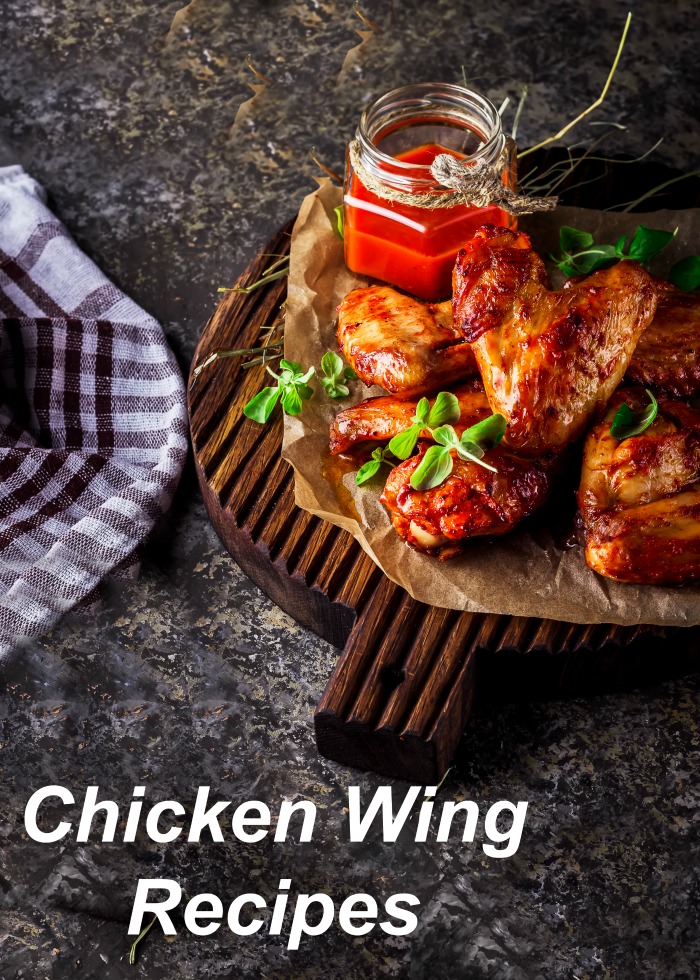 chicken wing Recipes For Super Chicken Wing Day: Chicken wings on a cutting board with sauce and a checked towel.