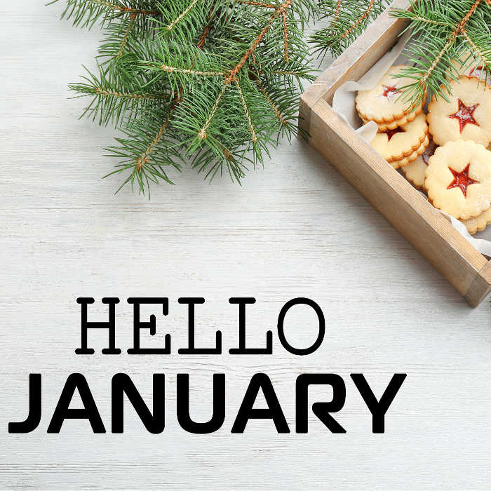 Cookies on a wooden tray with fir boughs and text reading "hello January."