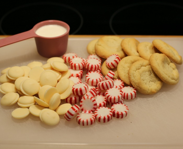 Ingredients for white chocolate peppermint cookies. Heavy cream, sugar cookies, peppermint candies and white candy wafers for white chocolate peppermint cookies.