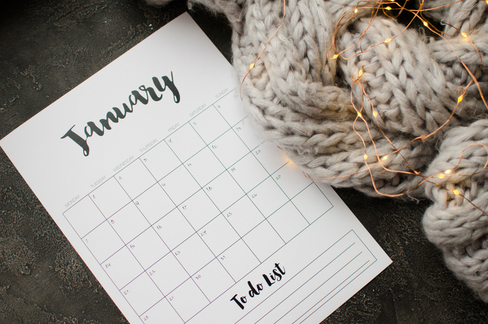 January national days calendar next to a scarf wrapped in twinkle lights.