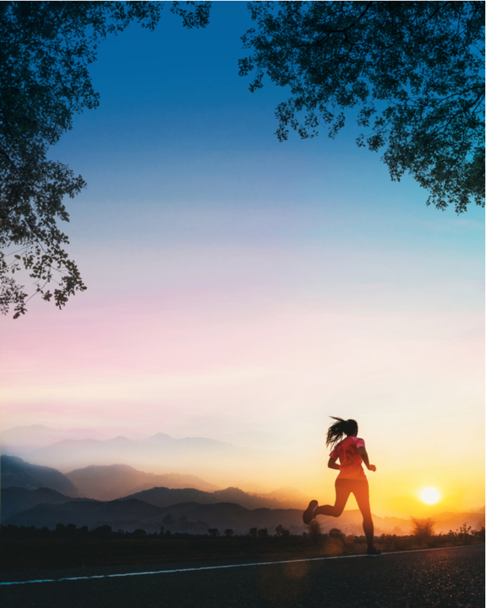 Woman running at sunrise for her new year's resolution.