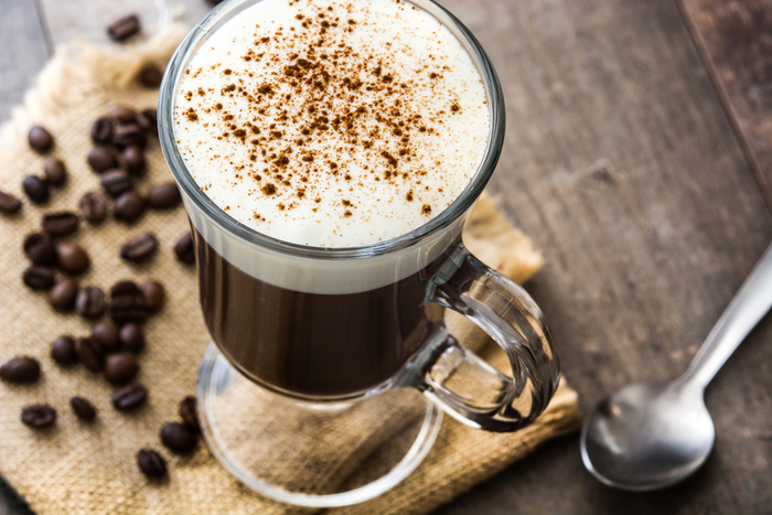 Irish coffee and coffee beans on a table. Irish coffee on a table with coffee beans to celebrate the history of Irish coffee.
