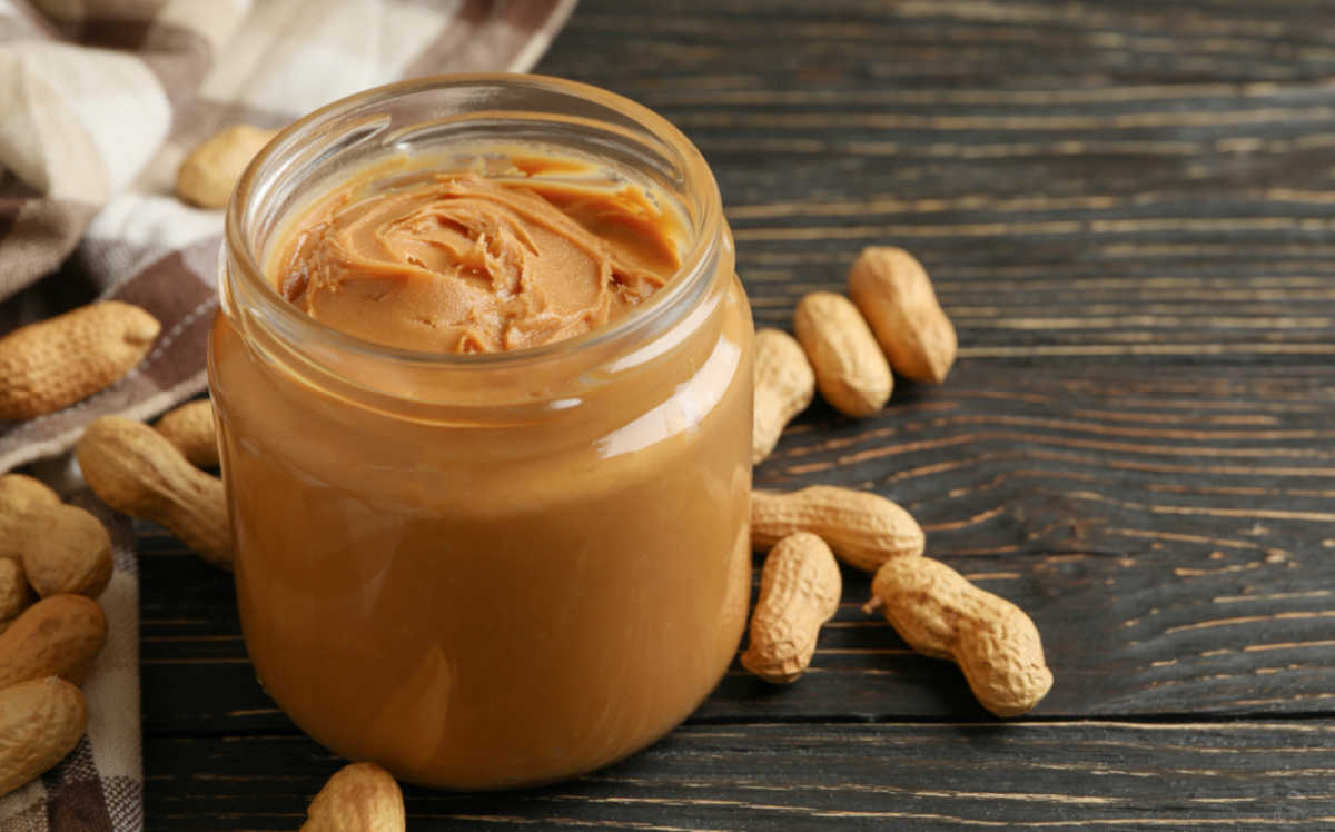 National peanut butter day. Jar of peanut butter and peanuts.