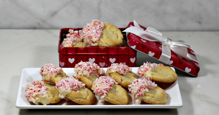 White chocolate peppermint cookies in a heart box and on a white plate.
