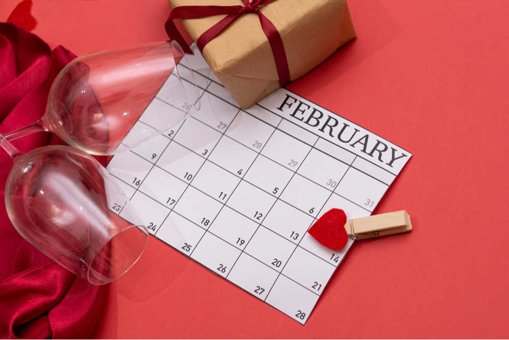 February calendar with present and heart pinned to it.