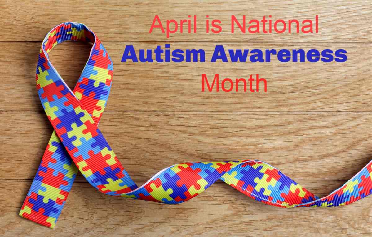 It's National Autism Awareness Month Multicolored jigsaw puzzle folded ribbon with words April is National Autism Awareness Month.