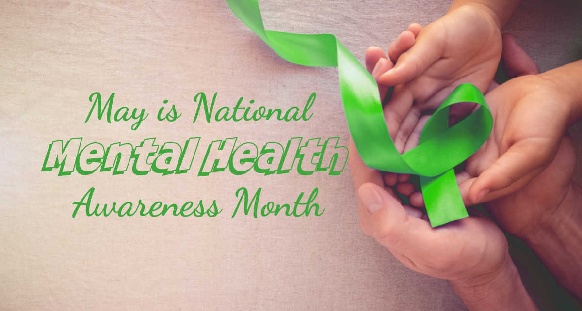 National Mental Health Awareness Month Hands holding a folded green ribbon and words May is National Mental Health Awareness Month.