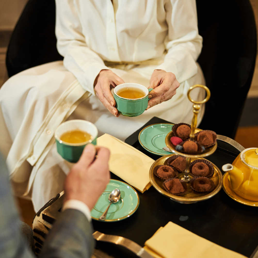 Tea ceremony with two people. Two people sitting down for tea at a tea ceremony.