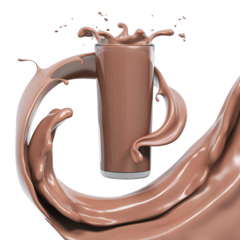 A glass of chocolate milk with chocolate milk swirling through the air around the glass.