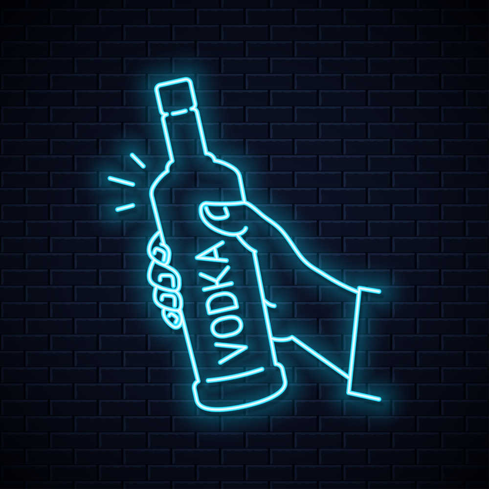 Neon vodka sign. A neon sign of a hand holding a bottle with the word "vodka" written on it vertically.