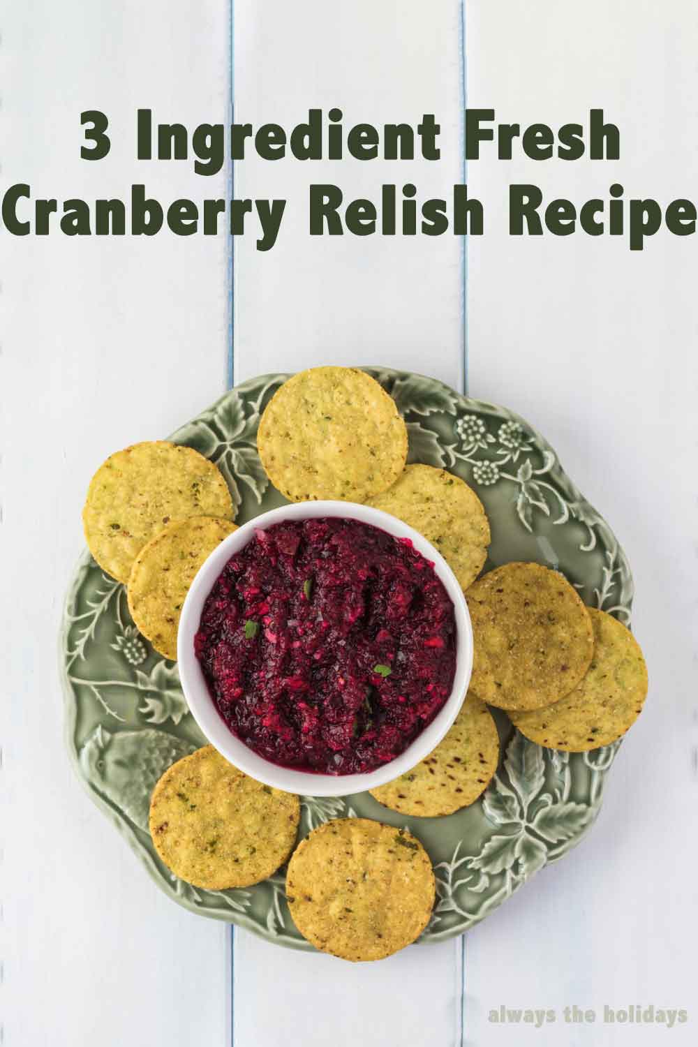 Cranberry relish and chips. A green plate with tortilla chips arranged in a circle around a ramekin of cranberry relish that is being served as a Thanksgiving side dish with a text overlay that says "3 ingredient fresh cranberry relish recipe".