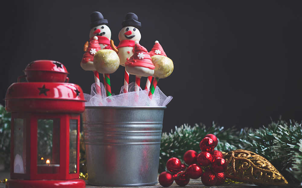 Snowman cake pops and hat cake pops with a red lantern.